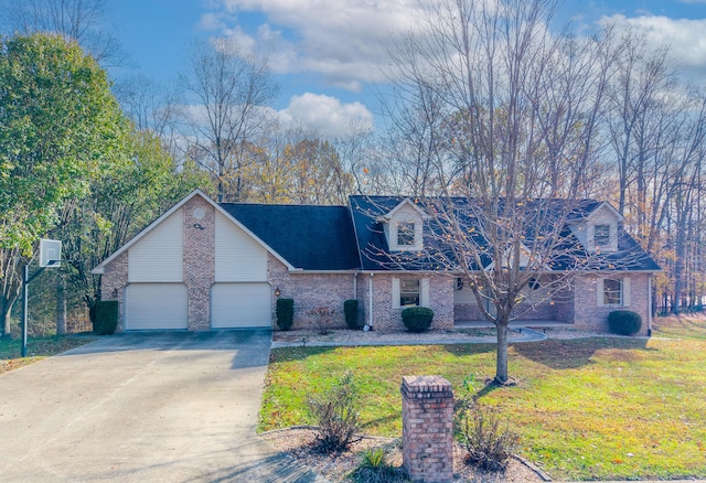 cape cod home with a garage and a front lawn