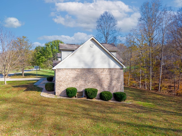 view of side of home featuring a yard