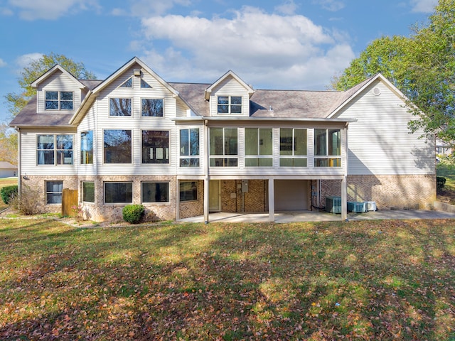 back of property featuring a yard, a patio, cooling unit, and a sunroom