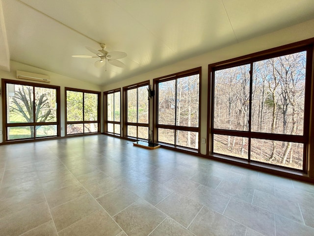 unfurnished sunroom featuring a wall mounted AC, plenty of natural light, lofted ceiling, and ceiling fan