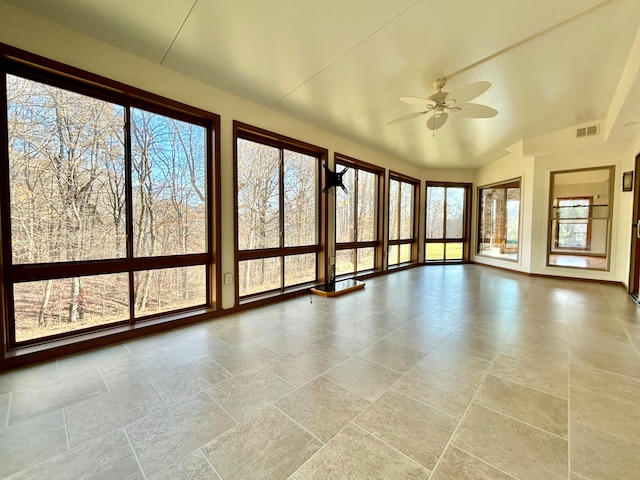 unfurnished sunroom with plenty of natural light, ceiling fan, and lofted ceiling