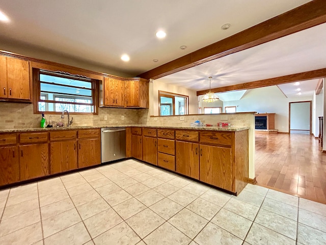 kitchen with dishwasher, hanging light fixtures, light hardwood / wood-style flooring, beamed ceiling, and kitchen peninsula