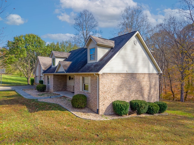 view of side of property with a patio and a lawn