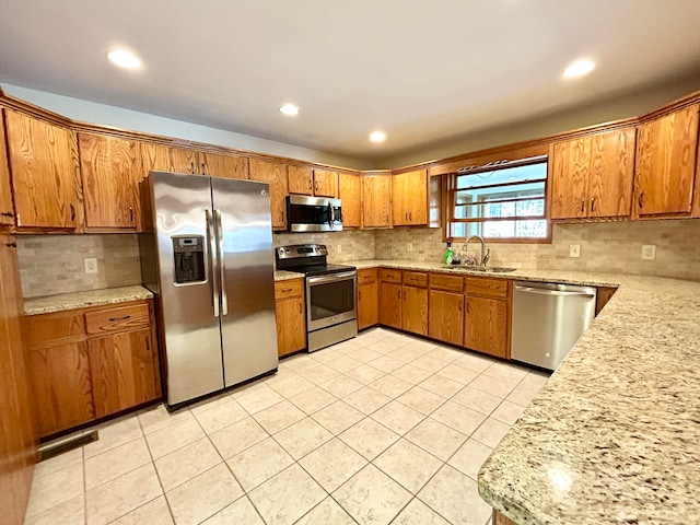 kitchen featuring decorative backsplash, sink, light tile patterned flooring, and stainless steel appliances