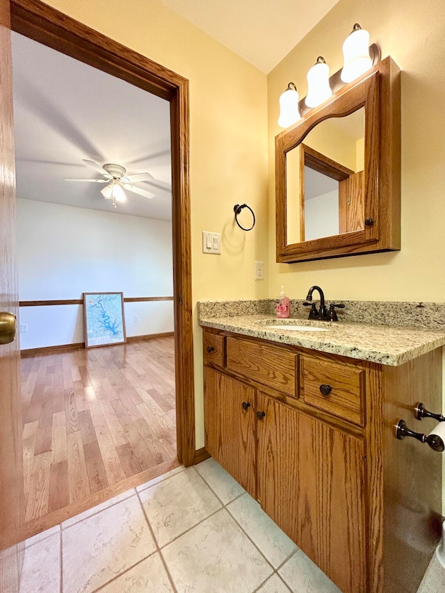 bathroom featuring vanity, hardwood / wood-style flooring, and ceiling fan