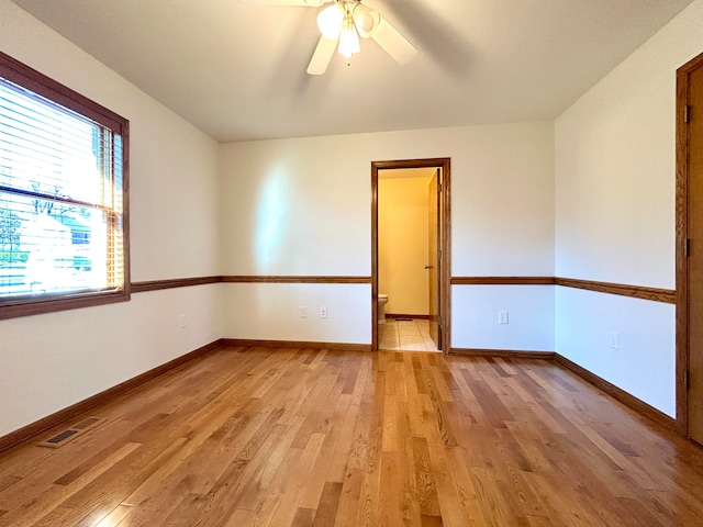 unfurnished room with ceiling fan and light wood-type flooring