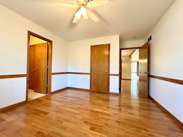 spare room featuring ceiling fan and light hardwood / wood-style flooring