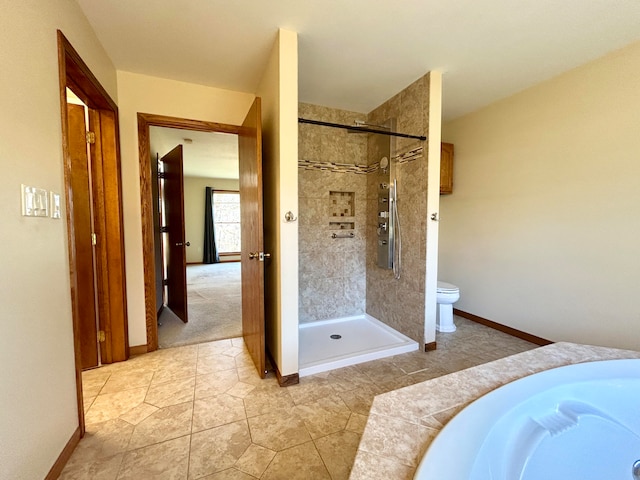 bathroom with a tile shower, sink, tile patterned flooring, and toilet