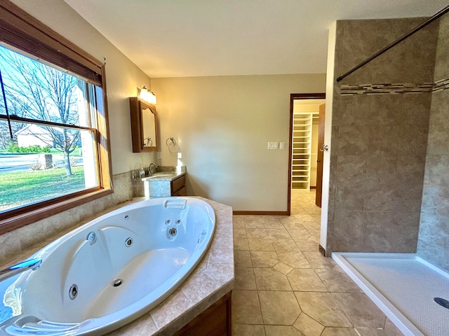 bathroom featuring tile patterned flooring, shower with separate bathtub, and vanity