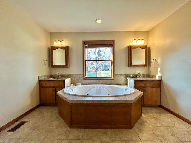 bathroom featuring vanity, tiled bath, and tile patterned floors