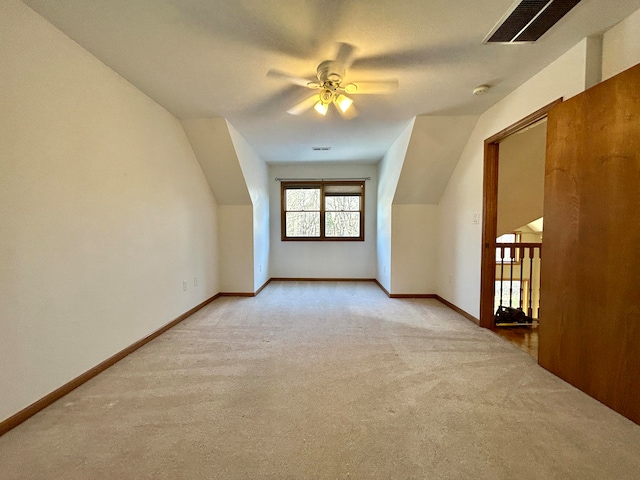 bonus room featuring ceiling fan, light colored carpet, and vaulted ceiling