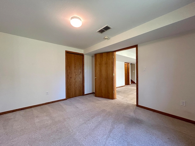 carpeted empty room with a textured ceiling