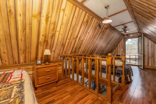 bedroom with wood walls, dark wood-type flooring, and lofted ceiling