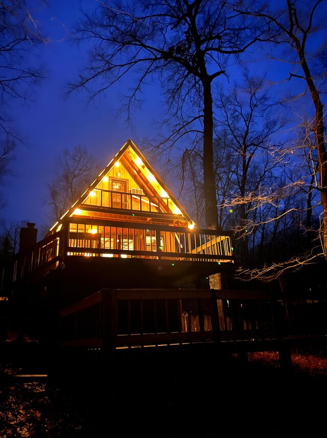 rear view of property featuring a wooden deck