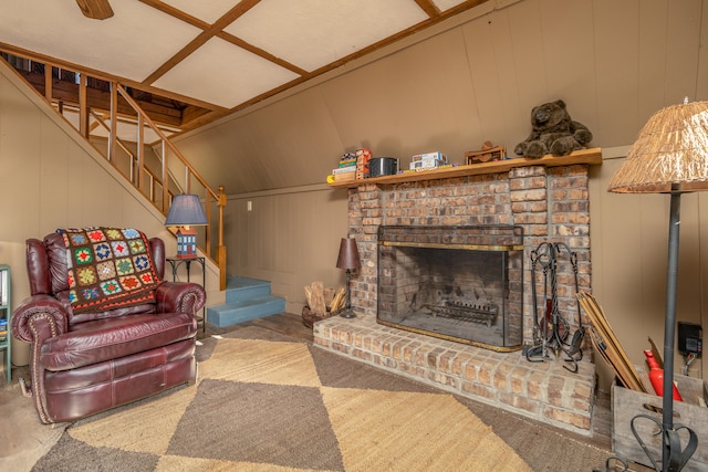 carpeted living room with a fireplace and lofted ceiling