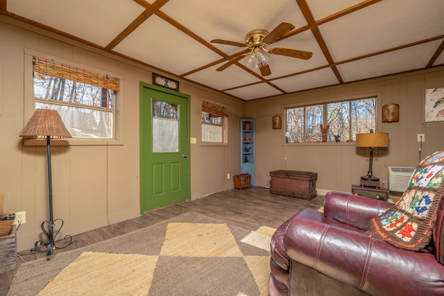 living room with coffered ceiling, hardwood / wood-style floors, ceiling fan, and plenty of natural light