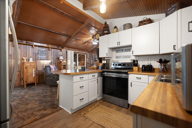 kitchen featuring white cabinetry, dark wood-type flooring, butcher block countertops, kitchen peninsula, and electric stove