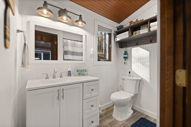 bathroom featuring wooden ceiling, hardwood / wood-style floors, vaulted ceiling, toilet, and vanity