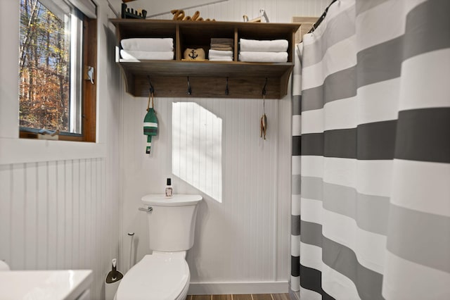 bathroom featuring hardwood / wood-style flooring and toilet