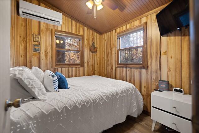 bedroom featuring an AC wall unit, wood walls, wood ceiling, and vaulted ceiling