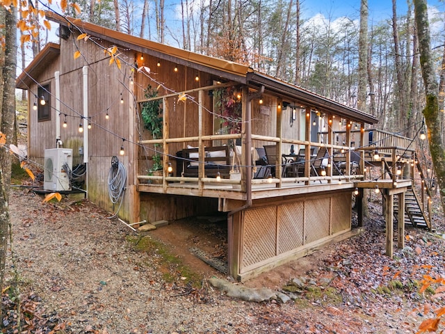 back of property featuring a wooden deck