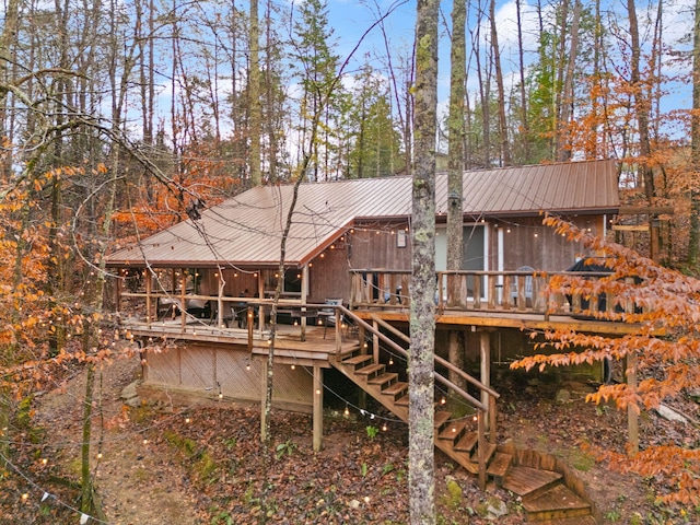 back of property featuring a wooden deck