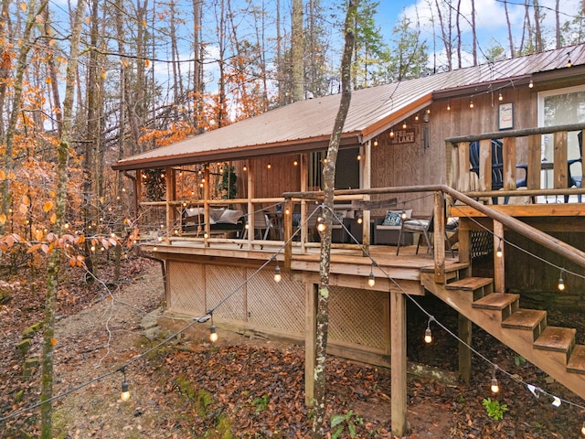 rear view of property featuring a wooden deck