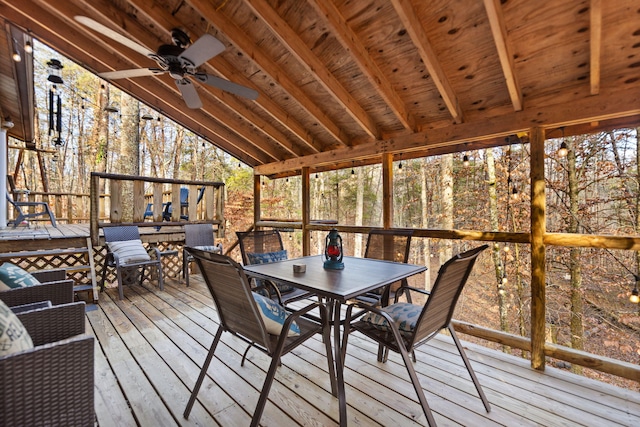 sunroom / solarium featuring vaulted ceiling with beams and ceiling fan