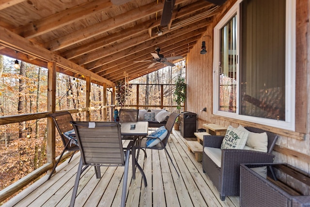 sunroom with lofted ceiling with beams and ceiling fan