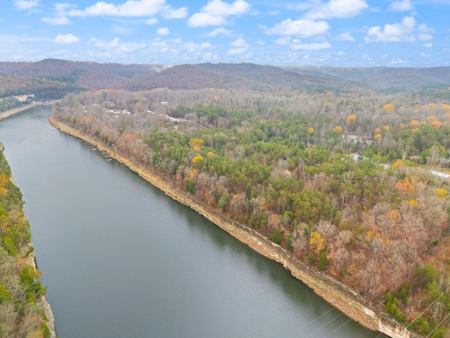 drone / aerial view featuring a water and mountain view