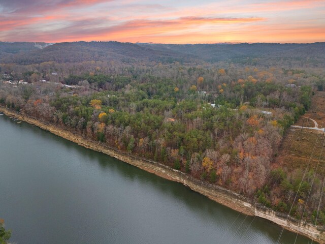 aerial view at dusk with a water and mountain view