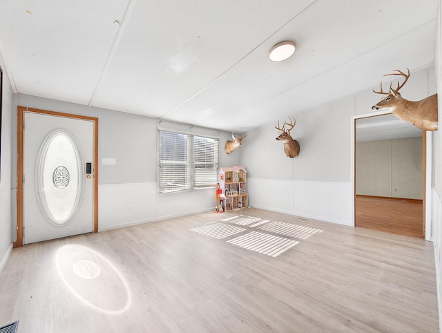 foyer entrance with light hardwood / wood-style floors