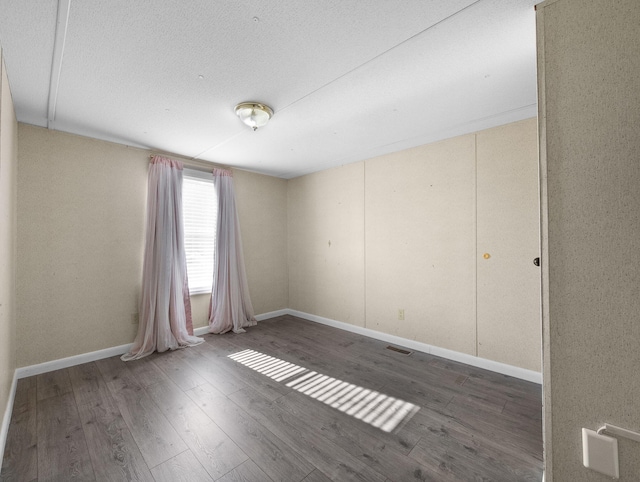 unfurnished room featuring hardwood / wood-style flooring