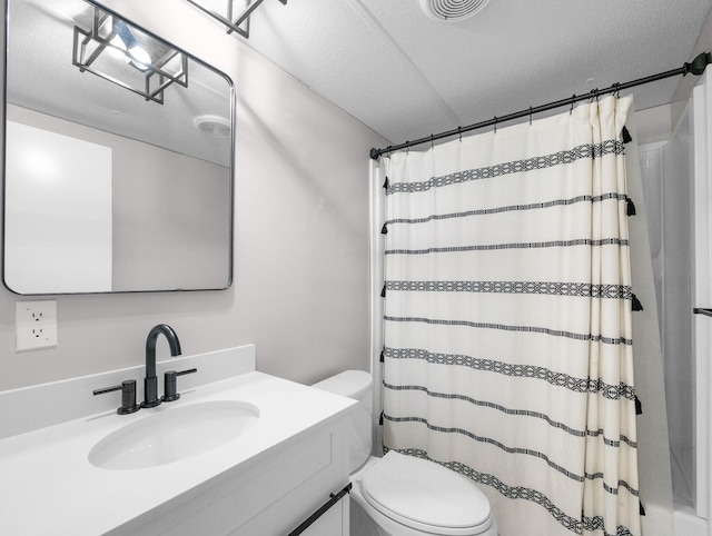 bathroom featuring walk in shower, vanity, and toilet