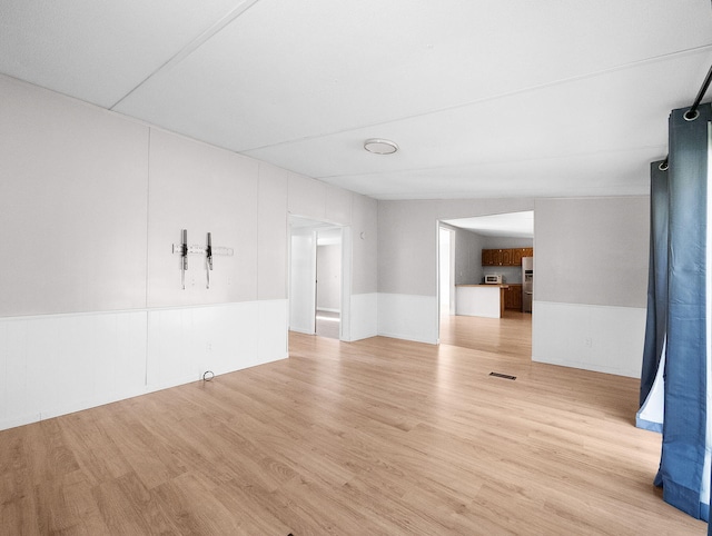 spare room featuring light wood-type flooring