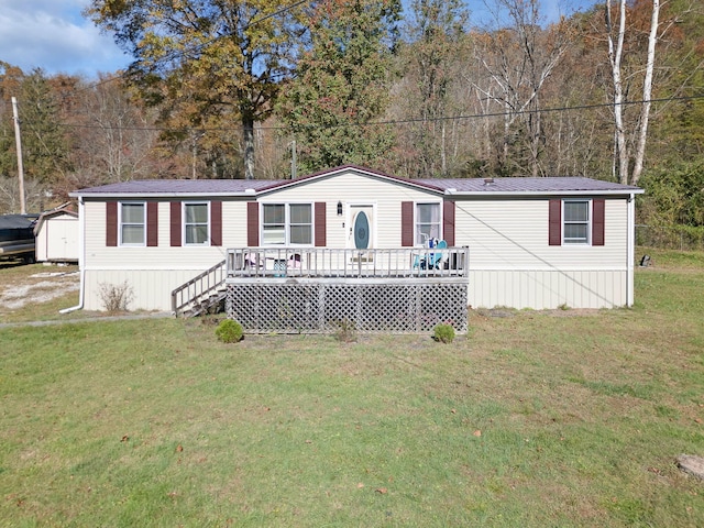 view of front facade featuring a front lawn and a wooden deck