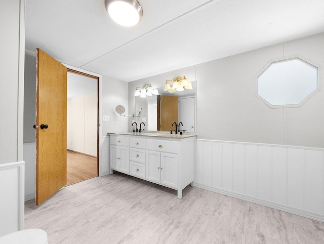 bathroom with hardwood / wood-style floors and vanity