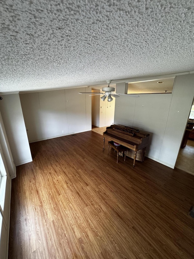 unfurnished living room with a textured ceiling and hardwood / wood-style flooring