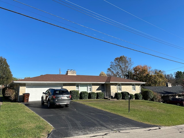 ranch-style home with a front lawn and a garage