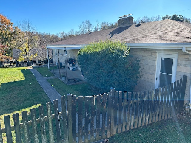 back of house featuring a lawn and a patio