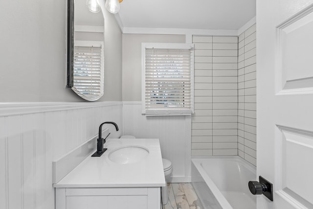 full bathroom featuring vanity, tiled shower / bath combo, and toilet