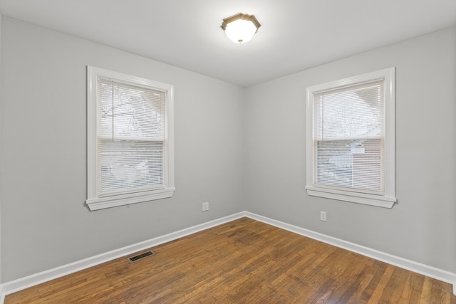 unfurnished room with plenty of natural light and hardwood / wood-style floors