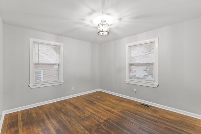 spare room featuring dark hardwood / wood-style flooring