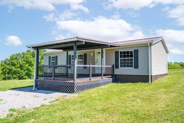 manufactured / mobile home featuring a front lawn and a porch