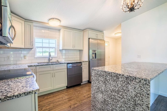 kitchen featuring hardwood / wood-style floors, sink, decorative backsplash, and appliances with stainless steel finishes