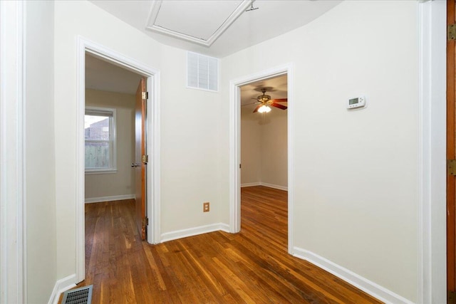 hallway with dark hardwood / wood-style flooring