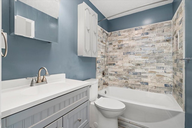 full bathroom with toilet, tiled shower / bath combo, vanity, and a textured ceiling