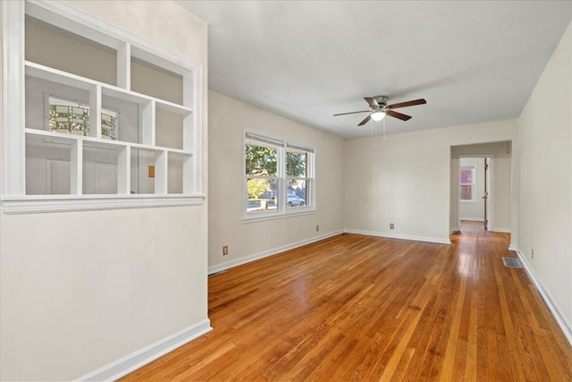 spare room featuring wood-type flooring and ceiling fan