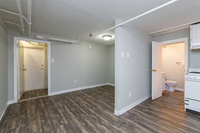 basement with dark hardwood / wood-style flooring