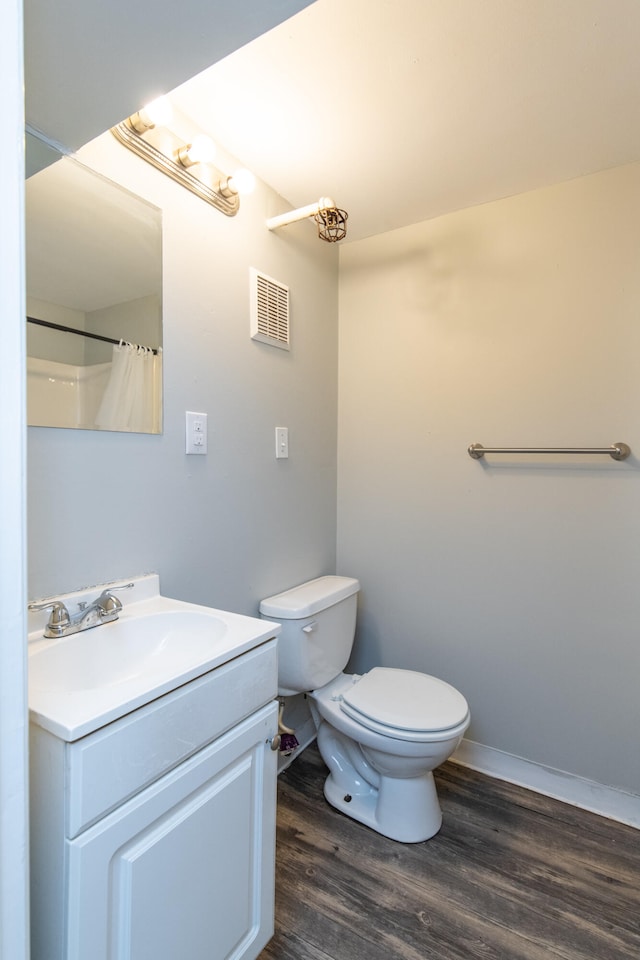 bathroom with toilet, vanity, a shower with shower curtain, and hardwood / wood-style flooring